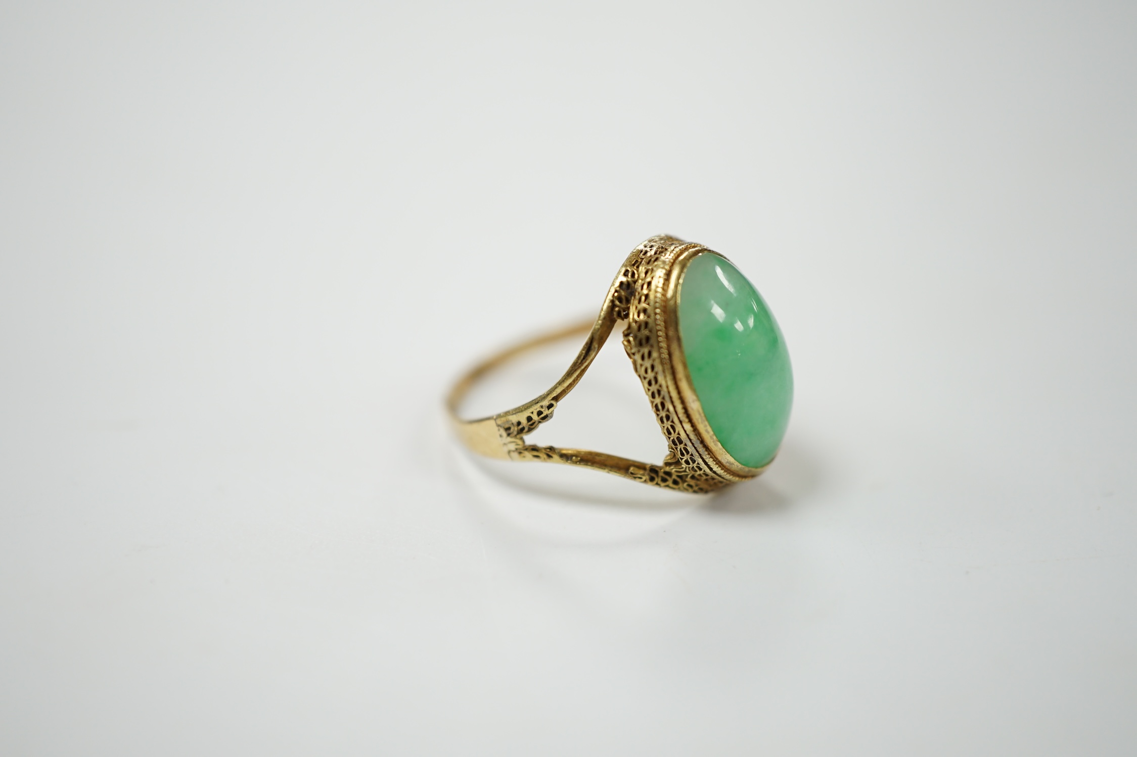 A Chinese 18k and cabochon jade set ring, size O, gross weight 3.9 grams. Condition - poor